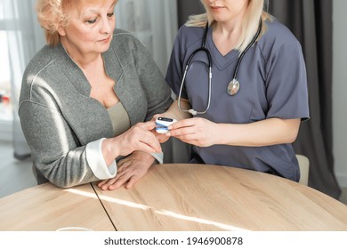 Doctor Measuring Patients Hemoglobin Level. Showing Usage Of Finger Pulse Oximeter