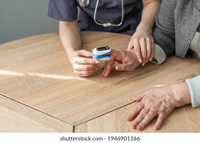 Doctor Measuring Patients Hemoglobin Level. Showing Usage Of Finger Pulse Oximeter