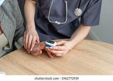 Doctor Measuring Patients Hemoglobin Level. Showing Usage Of Finger Pulse Oximeter