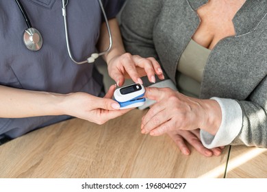 Doctor Measuring Patients Hemoglobin Level. Showing Usage Of Finger Pulse Oximeter