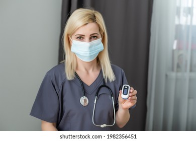 Doctor Measuring Patients Hemoglobin Level. Showing Usage Of Finger Pulse Oximeter