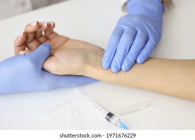 Doctor Measuring Pulse On Patient Forearm Near Empty Syringe And Medication Closeup