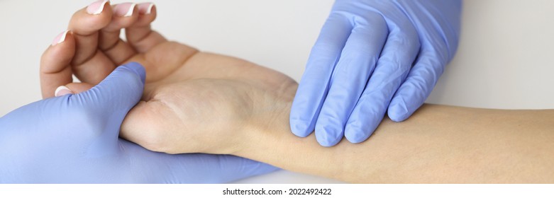 Doctor Measuring Pulse On Patient Forearm Near Empty Syringe And Medication Closeup