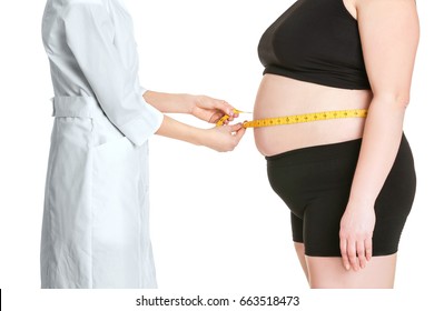 Doctor measuring stout adult woman on white background. Weight loss concept