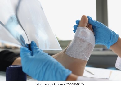 Doctor medical examination with leg injury and x-ray. Sprained and fractured feet concept - Powered by Shutterstock