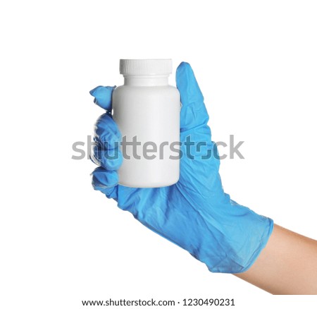 Doctor in medical glove holding bottle with pills on white background
