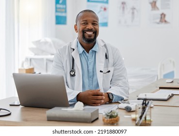 Doctor, Medical Healthcare Worker And Male Physician At Hospital Or Clinic Working With Stethoscope And Electronics. GP Man On Laptop Reading Emails, Patient Records And Documents In Covid Pandemic