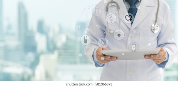 Doctor Or Medical Students Using Digital Tablet With Medical Icon At Hospital. Medical Technology Network Concept. Copy Space.
