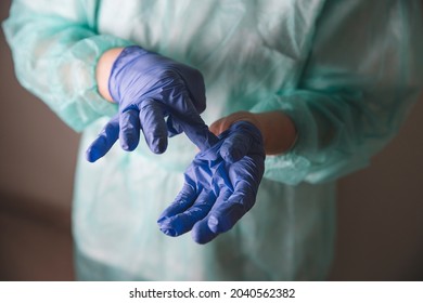 Doctor Medical Worker Taking Off Blue Latex Gloves