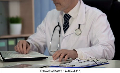 Doctor Of Medicine Writing Scientific Article For Magazine, Working On Laptop