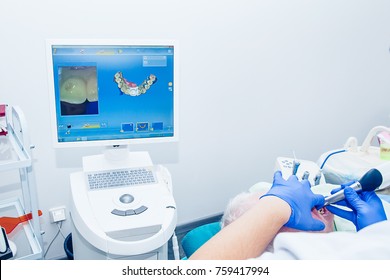 Doctor modeling prosthesis using CAD CAM dental computer-aided machine in a highly modern dental laboratory. Dentistry, prostodontics, prosthetics and medical computer technology concept