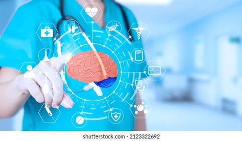 Doctor neurologist in a medical uniform points a finger at the brain with medical icons, birth defects of the brain. Soft blurred hospital background. Medical poster. High quality photo