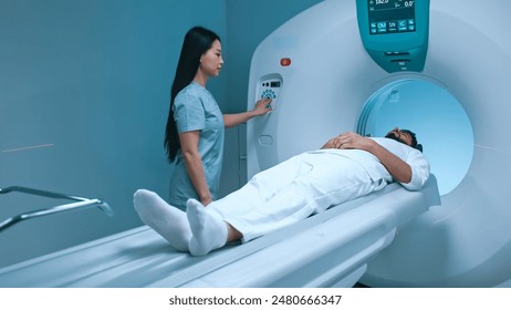 Doctor neurologist performing CT scan for patient at diagnostic clinic. Medical girl nurse putting buttons on MRI device. Magnetic resonance imaging in study of human body. Medicine, healthcare. - Powered by Shutterstock