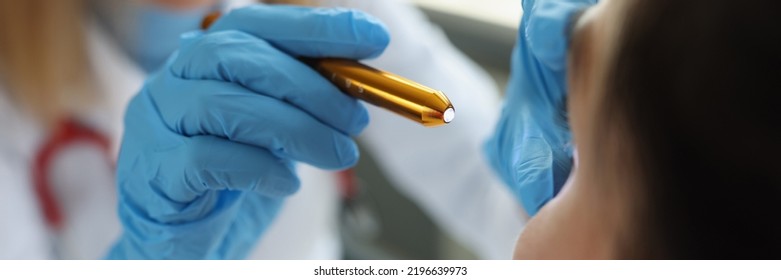 Doctor Neurologist Shining Flashlight On Patient Eyes In Clinic Closeup. Diagnosis Of Neurological Diseases Of Brain Concept