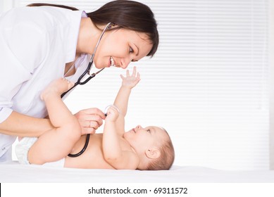 Doctor With Newborn On A White