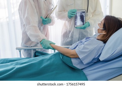 Doctor And Nurse Assistants Working With Patients Coronavirus COVID-19 Infection Are Being Examined In A Special Room, Private Room, Quarantine Room. The Doctors And The Patients In The Cleanroom 