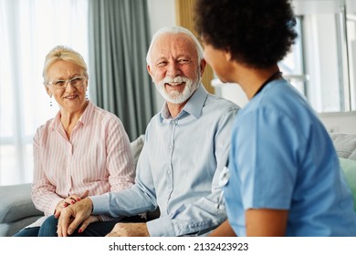 Doctor or nurse caregiver with senior couple at home or nursing home - Powered by Shutterstock