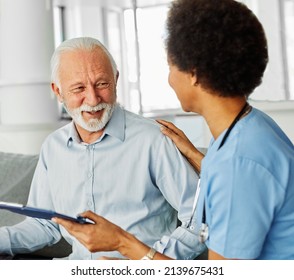 Doctor Or Nurse Caregiver With Senior Man Holding Walking Cane At Home Or Nursing Home