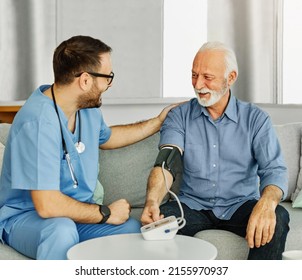 Doctor Or Nurse Caregiver With Senior Man At Home Or Nursing Home