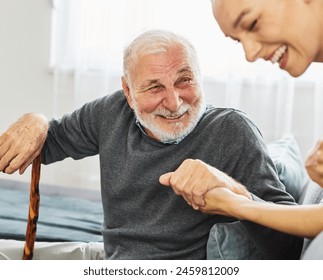 Doctor or nurse caregiver with senior man holding walking cane at home or nursing home - Powered by Shutterstock