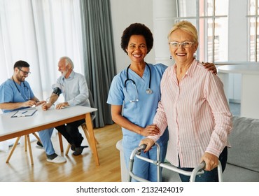 Doctor or nurse caregiver with senior woman using walker assistanece  at home or nursing home - Powered by Shutterstock