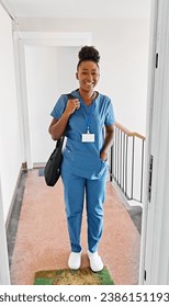 Doctor or nurse caregiver with senior woman at home or nursing home, a caregiver standing on the front door arriving and being welcomed by a senior woman