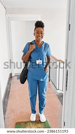 Doctor or nurse caregiver with senior woman at home or nursing home, a caregiver standing on the front door arriving and being welcomed by a senior woman