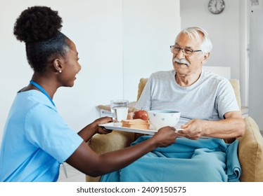 Doctor or nurse caregiver serving a meal to senior man at home or nursing home - Powered by Shutterstock