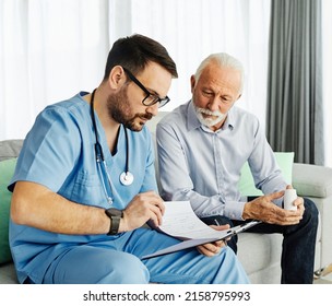 Doctor or nurse caregiver showing a prescrption or documents and holding drug bottle to senior man at home or nursing home - Powered by Shutterstock