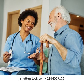 Doctor or nurse caregiver showing a prescrption drug to senior man at home or nursing home - Powered by Shutterstock