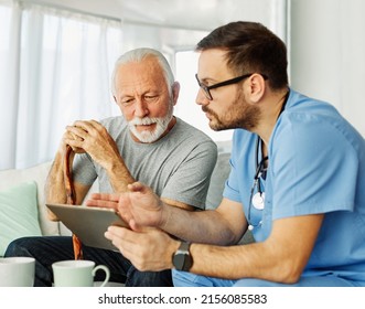 Doctor or nurse caregiver showing a tablet screen to  senior man and laughing at home or nursing home - Powered by Shutterstock