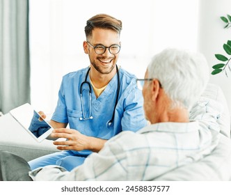 Doctor or nurse caregiver showing a tablet screen to  senior man at home or nursing home - Powered by Shutterstock