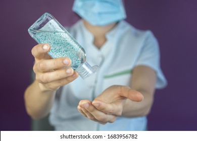 Doctor nurse cleaning and sanitizing or desinfecting hands with hand sanitizer or soup because of Coronavrius Covid-19 - Powered by Shutterstock