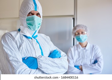 Doctor and nurse in clinic with protective clothing during Covid-19 pandemic - Shutterstock ID 1684400116