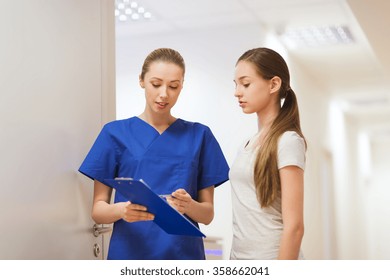 Doctor Or Nurse With Clipboard And Girl Patient