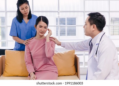 Doctor And Nurse Comforting Patients From Stress After Receiving Bad Medical News About Illness Symptom. Adult Woman Feel Bad Headache When Diagnosed With Cancer.