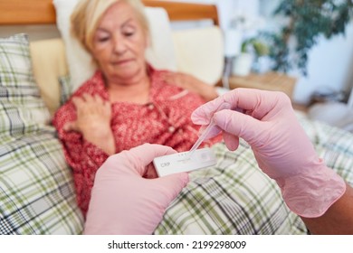 Doctor Or Nurse Evaluating The CRP Test Of A Senior Citizen In A Nursing Home