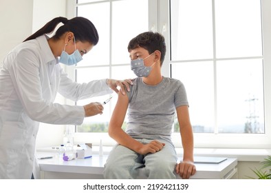 Doctor Or Nurse Gives Shot To School Boy. Child Gets Injection In New Clean White Medical Office. Kid Gets Vaccine For Covid, Flu, Monkeypox Or Other Contagious Disease. Children's Vaccination