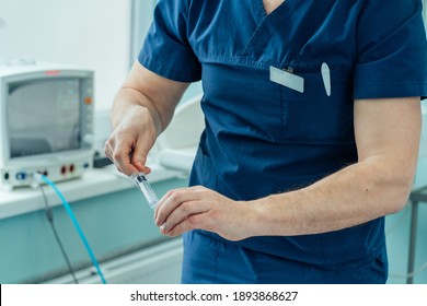 Doctor Or Nurse Hand In Holding Syringe Injection For Epidural Anesthesia.