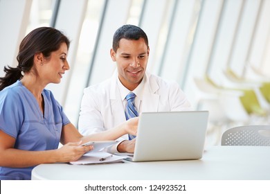 Doctor And Nurse Having Informal Meeting In Hospital Canteen