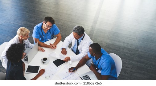 Doctor, nurse and healthcare professional team or group sitting in the boardroom, talking about medicine and discussing treatment during a meeting. Planning and brainstorming a health cure from - Shutterstock ID 2186527265