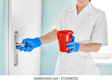 Doctor Nurse Holding A Red Box With A Dangerous Substance In The Hospital Opens The Door