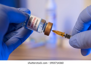 Doctor or Nurse holding syringe and COVID-19 vaccine. Healthcare And Medical concept.