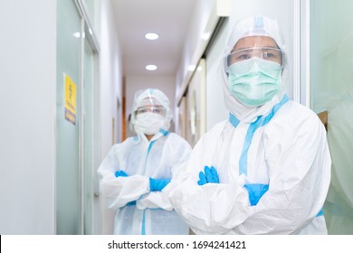 Doctor and nurse in personal protective equipment or ppe including white suit, mask, face shield and gloves are discussing about treatment of pateint with coronavirus. covid-19, quarantine  concept