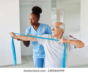 Doctor or nurse or physiotherapist caregiver exercise with senior man at clinic or nursing home - Powered by Shutterstock