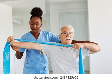 Doctor or nurse or physiotherapist caregiver exercise with senior man at clinic or nursing home - Powered by Shutterstock