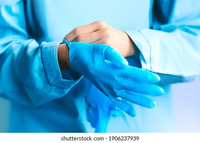 Doctor or nurse putting on sterile gloves. Close up concept. Virus. Testing covid 19. Ready for vaccination.   - Powered by Shutterstock