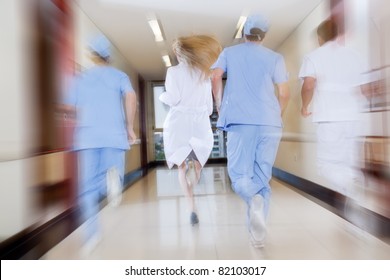 Doctor and nurse running in passageway of hospital