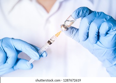 Doctor, nurse, scientist hand in blue gloves holding flu, measles, coronavirus, covid-19 vaccine disease preparing for child, baby, adult, man and woman vaccination shot, medicine and drug concept.