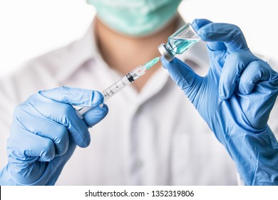 Doctor, Nurse, Scientist Hand In Blue Gloves Holding Flu, Measles, Coronavirus, Covid-19 Vaccine Disease Preparing For Child, Baby, Adult, Man And Woman Vaccination Shot, Medicine And Drug Concept.